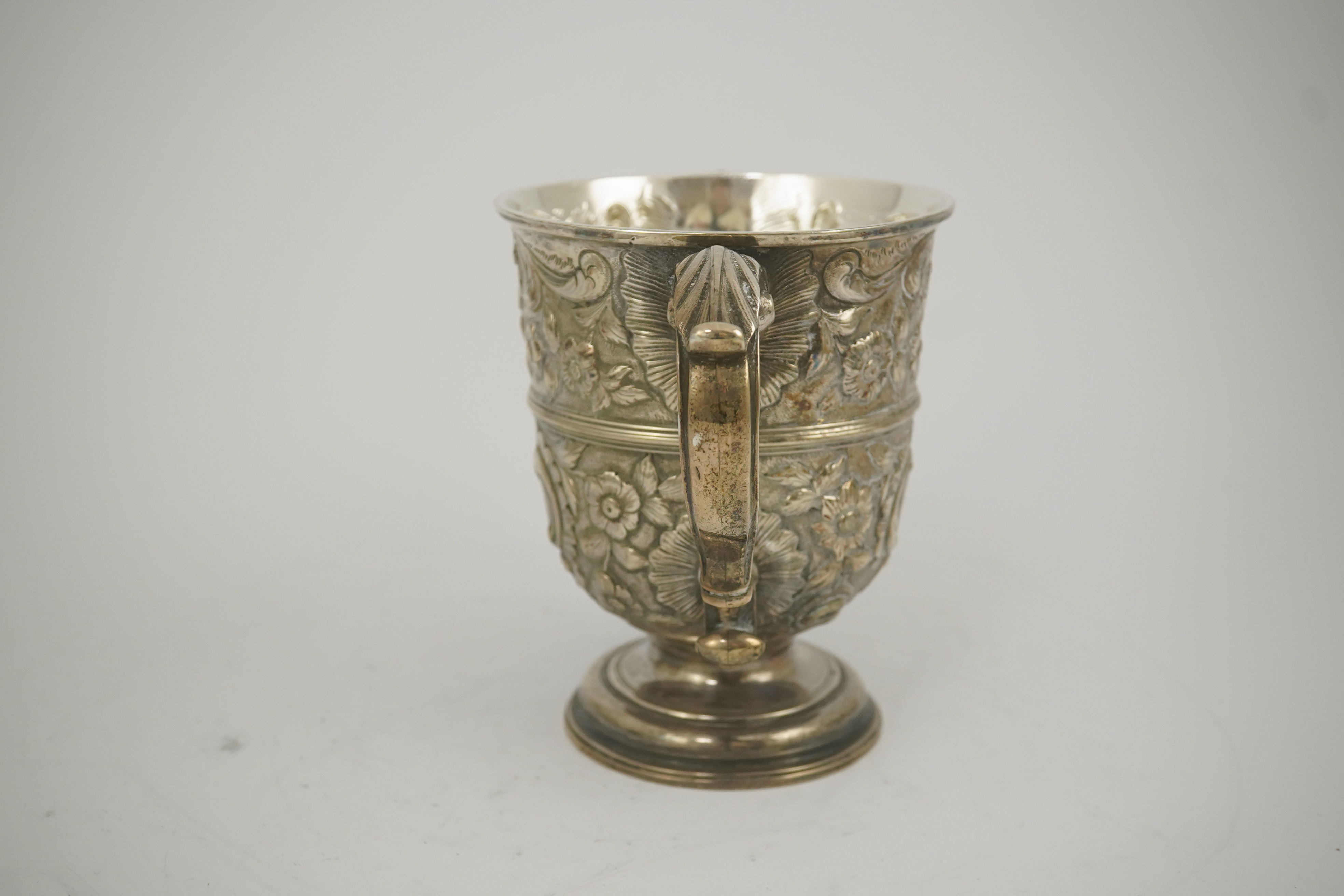 A George II silver loving cup with later floral embossed decoration, maker's initials RI, London, 1745